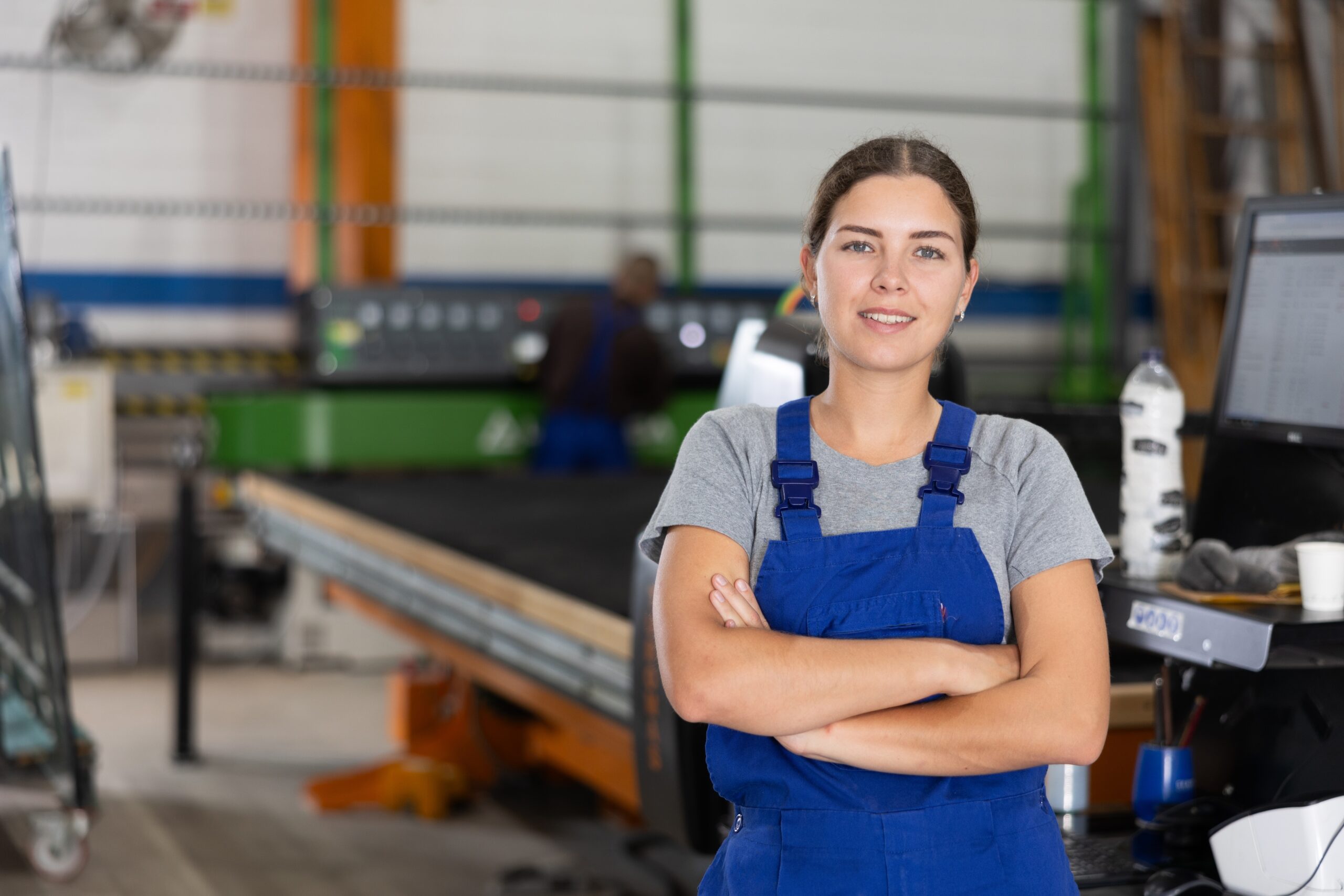 Confident,Smiling,Young,Female,Worker,Posing,With,Crossed,Arms,In
